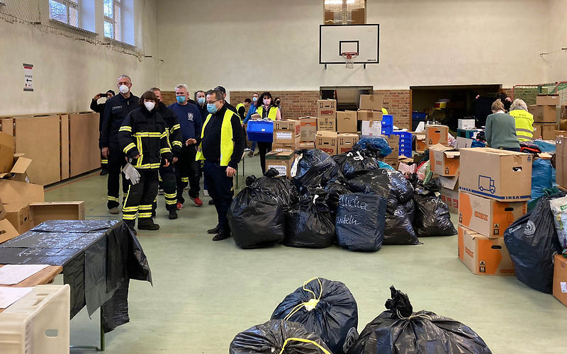 Kameraden der Freiwilligen feuerwehr verstauen die Sachspenden auf einem LKW