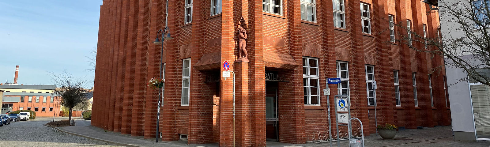 Rathaus in der Promenade: Ein großes Backsteingebäude mit weißen Fenstern.